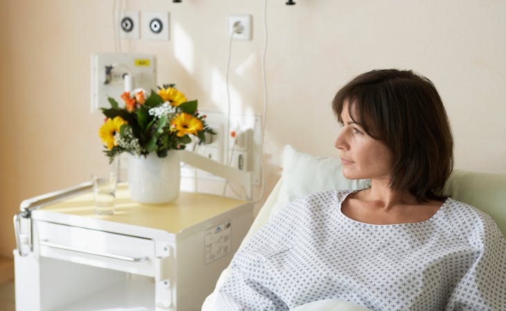 person in hospital bed with insomnia after surgery