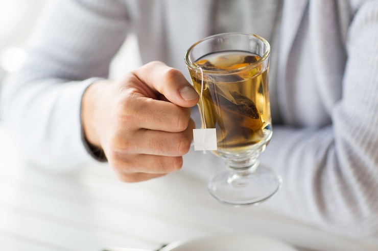 person holding cup of tea