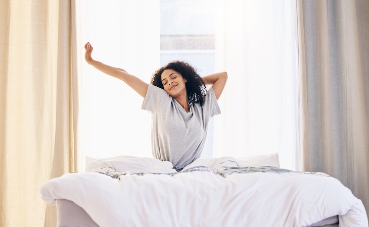 Person stretching in a bright room