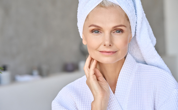 Lady touching her face in a robe