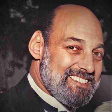Photo of Sandy Rudzin, Ron Rudzin's father He is dressed in a tuxedo and is smiling at the camera